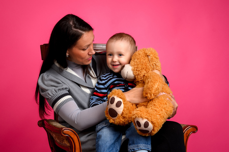 Mother and son sitting in a chair, Studioの写真素材