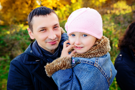 A father with daughter baby in autumn forestの写真素材