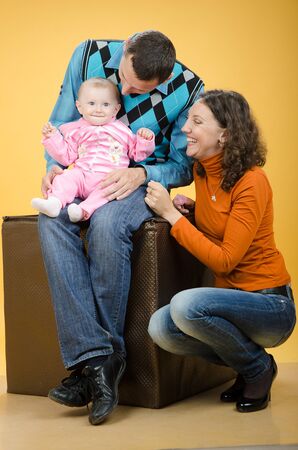 Parents and daughter, on an orange backgroundの写真素材