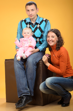 Parents and daughter, on an orange backgroundの写真素材