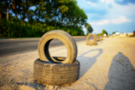 automobile tires corn field close-up, blurry.Old wheel on the roadの写真素材