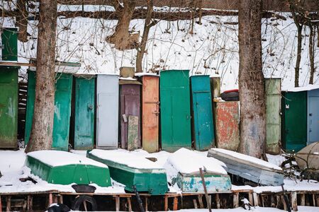 Winter landscape with fisherman boats lying on frozen lake shore. Winter lake landscapeの写真素材