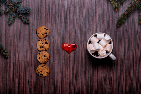 Ceramic Mug coffee, chocolate cookies, dark board and the heart symbol in the middleの写真素材