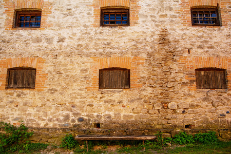 The six windows on an old building crammed boards, building with bricksの写真素材