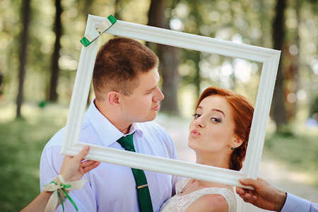 groom and bride posing in a white frame.の写真素材