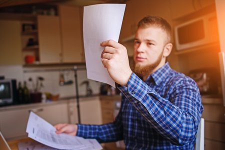 Businessman at home, he is working with of paper.