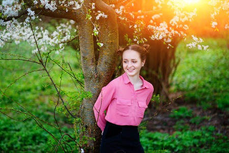Sensuality. Happy beautiful young woman relaxing in blossom park.の写真素材