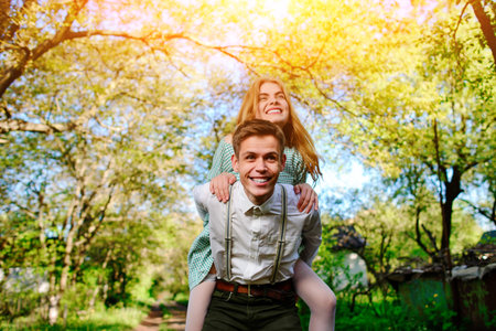 Portrait of happy couple raising their hands in open air.の写真素材