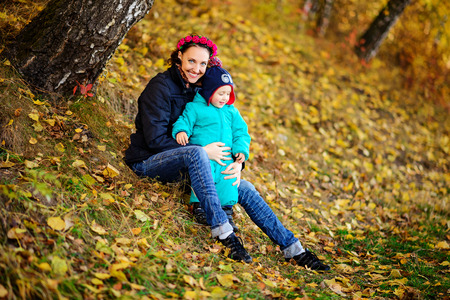 Mother with son in autumn peach garden, lovely sunny dayの写真素材