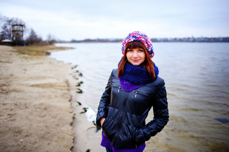 pretty girl posing near mountain lake. autumn lanscape in forest.の写真素材