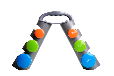 Set of colored isolated dumbbells for sport on a white background folded on a special gray stand.の写真素材