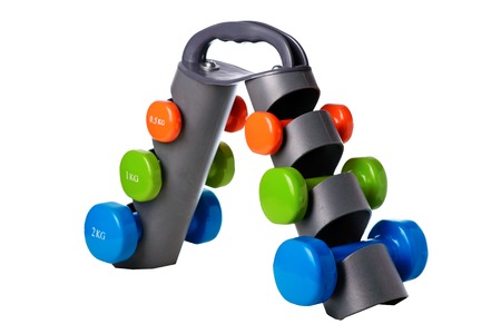 Set of colored isolated dumbbells for sport on a white background folded on a special black stand.の写真素材