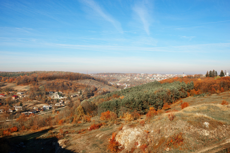 View on the beautiful colorful autumn landscape of the hills with trees and greenfields in the countryside.の写真素材