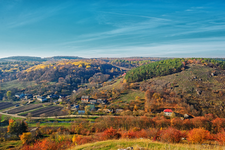 View on the beautiful colorful autumn landscape of the hills with trees and greenfields in the countryside.の写真素材