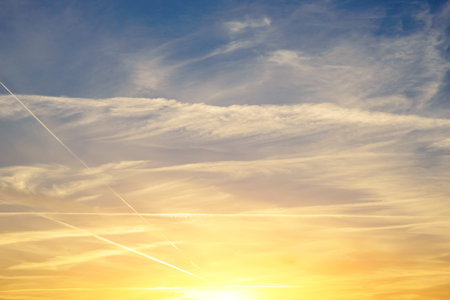 Background of the sunset with blue and gold cloudy sky.