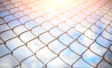 Blue sky behind a metal grate, backgroundの写真素材
