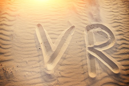 The word VR is written on the sand on a wonderful sunny day.の写真素材