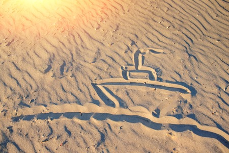 the ship is drawn on sandy beach.の写真素材