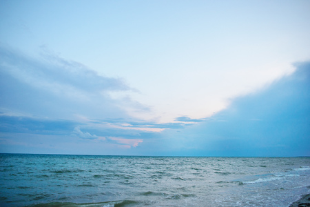 the blue ocean with dull clouds on a lovely sunny day.の写真素材