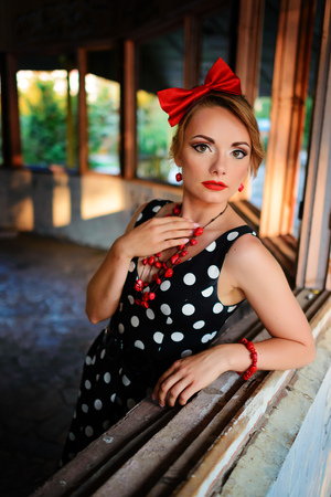 beautiful young woman posing in retro dress.の写真素材