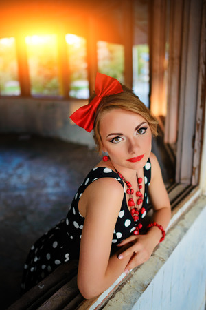 beautiful young woman posing in retro dress.の写真素材
