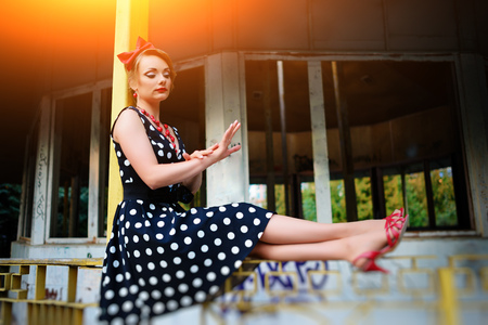 beautiful young woman posing in retro dress.の写真素材