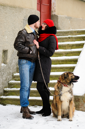 Happy couple with dogs in winter forest. Lovely moments outdoor holidays.の写真素材