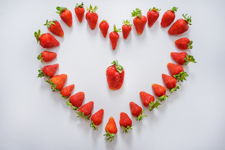 Heart of strawberry. Strawberry heart on white background. Love of strawberries.の写真素材