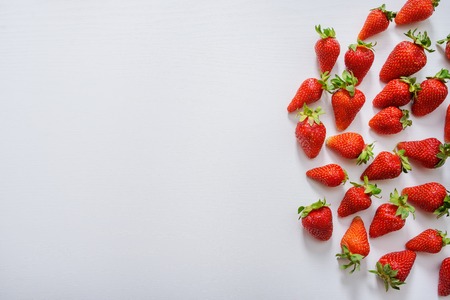 strawberry fruits on the right side on wooden background with copy space. View from aboveの写真素材