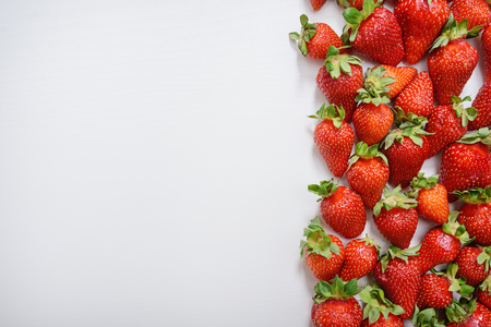 strawberry fruits on the right side on wooden background with copy space. View from aboveの写真素材