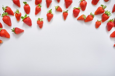 strawberry fruits on the right side on wooden background with copy space. View from above.の写真素材