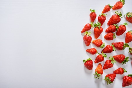 strawberry fruits on the right side on wooden background with copy space. View from aboveの写真素材