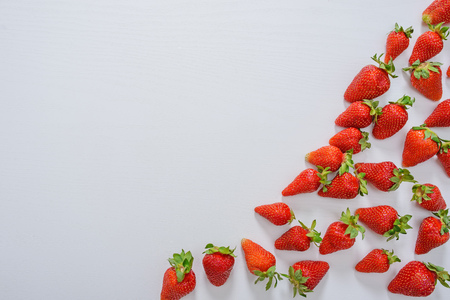 strawberry fruits on the right side on wooden background with copy space. View from aboveの写真素材
