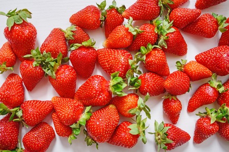 Fresh strawberry. Strawberries on white concrete background. Harvest of organic local strawberries.の写真素材