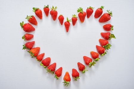 Heart of strawberry. Strawberry heart on white background. Love of strawberries.の写真素材
