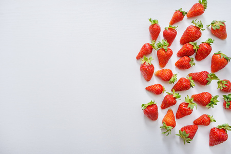 strawberry fruits on the right side on wooden background with copy space. View from aboveの写真素材