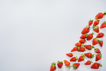 strawberry fruits on the right side on wooden background with copy space. View from aboveの写真素材