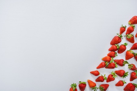 strawberry fruits on the right side on wooden background with copy space. View from aboveの写真素材