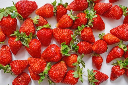 Fresh strawberry. Strawberries on white concrete background. Harvest of organic local strawberries.の写真素材