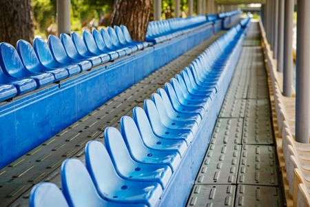 Empty plastic chairs in the stands of the stadium.の写真素材