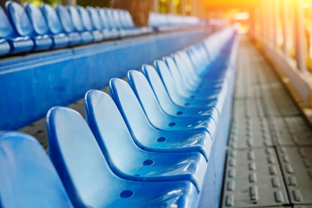Empty plastic chairs in the stands of the stadium.の写真素材