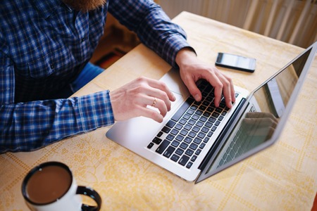 Closeup of businessman is keyboarding on portable net-book.の写真素材
