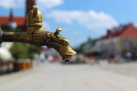 August 7, 2022 Bialystok Poland. Faucet and water drop well of city center.の写真素材