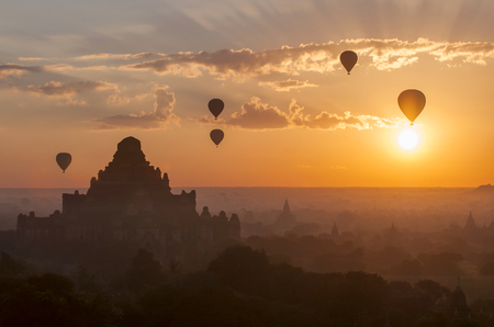 Hot air balloon over plain of Bagan in misty morning, Myanmar.の写真素材