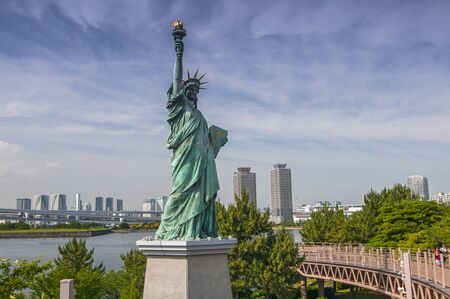 Replicas of the Statue of Liberty with cityscape background at Odaiba Park in Tokyo, Japan.の写真素材