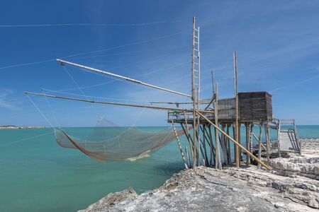Typical traditional fishing trabucco at the beach of Vieste along the Adriatic Sea in Puglia, Italy.の写真素材