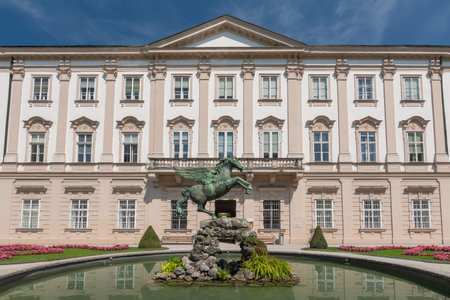 Facade of Schloss Mirabell Palace, with a bronze Pegasus on Pegasus Fountain in front, sculptor Kaspar Gras, Salzburg Austria.