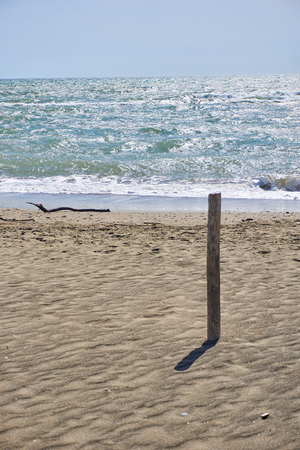beach and blue sea with wooden postの写真素材