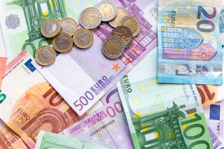 Bunch of european money with coins and bank notes show international finance with euro and europe as financial market and financial trade in a global marketの写真素材