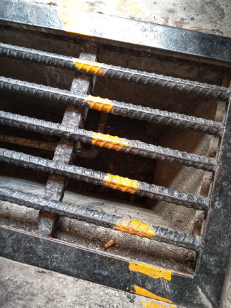 Cover the water drain made of sturdy iron in the road area.の写真素材